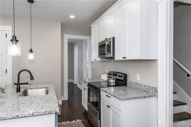 4370 Dayton Liberty Rd, Dayton, OH 45417 - kitchen with stainless steel appliances, a sink, dark wood-type flooring, white cabinets, and recessed lighting