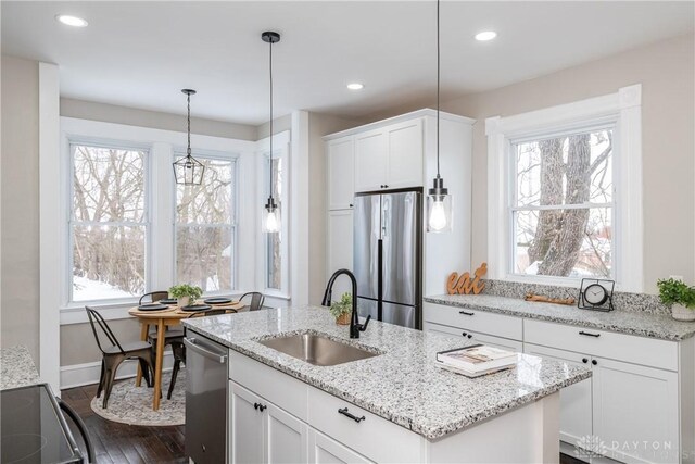 4370 Dayton Liberty Rd, Dayton, OH 45417 - kitchen with stainless steel appliances, a sink, dark wood-type flooring, a center island with sink, and white cabinets