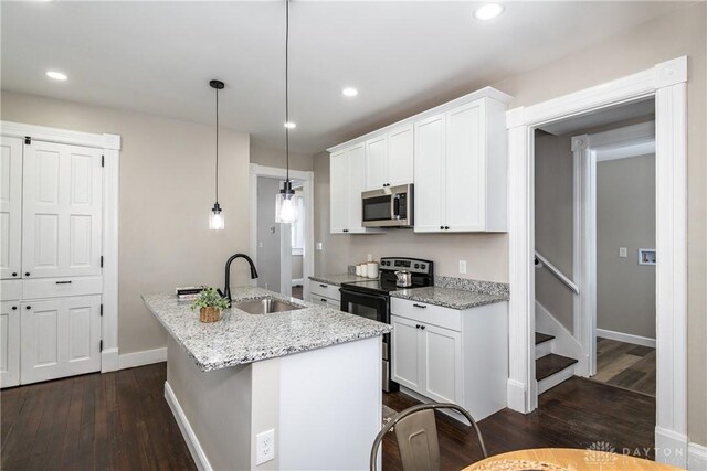 4370 Dayton Liberty Rd, Dayton, OH 45417 - kitchen with stainless steel microwave, electric range, a sink, dark wood-type flooring, and white cabinets
