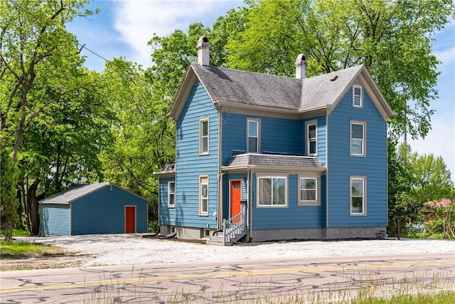 4370 Dayton Liberty Rd, Dayton, OH 45417 - view of front of property with entry steps, an outbuilding, a chimney, and a shingled roof