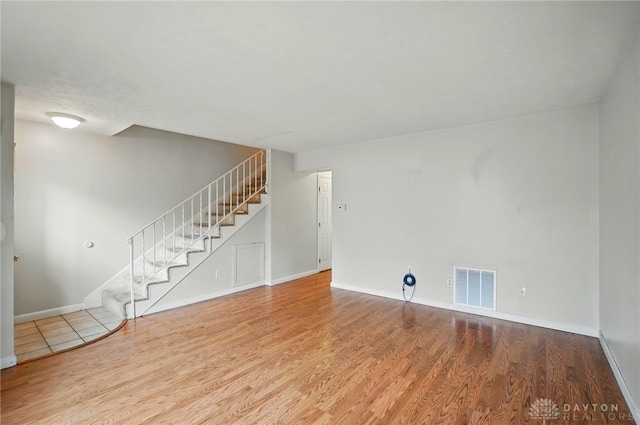 729 Clareridge Ln, Dayton, OH 45458 - unfurnished living room with stairs, wood finished floors, and baseboards