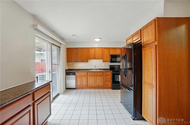 729 Clareridge Ln, Dayton, OH 45458 - kitchen featuring black appliances, a sink, dark countertops, and light tile patterned floors