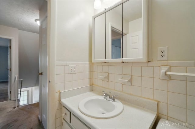 729 Clareridge Ln, Dayton, OH 45458 - bathroom featuring tile walls, vanity, and a textured ceiling