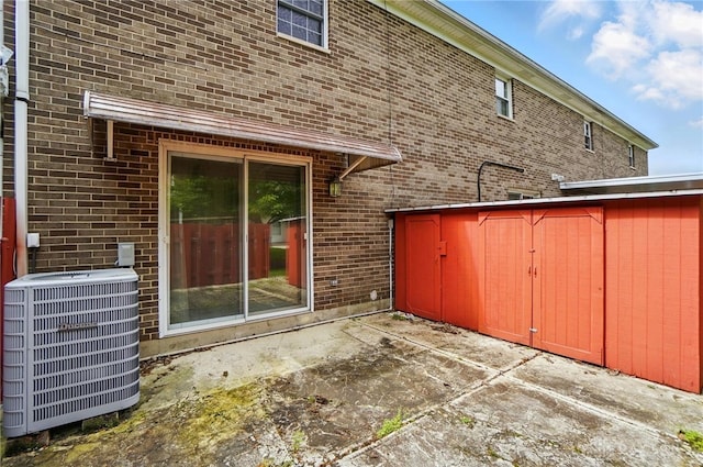 729 Clareridge Ln, Dayton, OH 45458 - back of property featuring cooling unit, a patio area, and brick siding