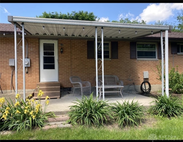 10520 Grand Vista Dr, Dayton, OH 45458 - rear view of house with entry steps, a patio area, and brick siding