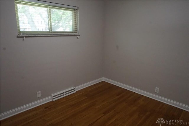 10520 Grand Vista Dr, Dayton, OH 45458 - spare room featuring dark wood-style floors and baseboards