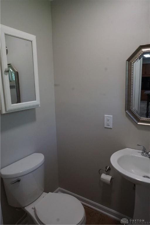 10520 Grand Vista Dr, Dayton, OH 45458 - half bathroom with toilet, a sink, and baseboards