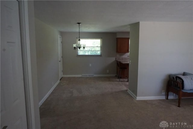 10520 Grand Vista Dr, Dayton, OH 45458 - unfurnished dining area featuring light carpet, a chandelier, and baseboards