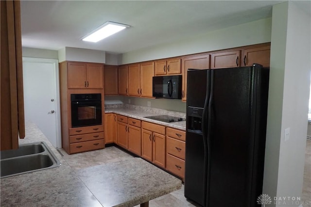 10520 Grand Vista Dr, Dayton, OH 45458 - kitchen with black appliances, a sink, brown cabinets, and light countertops