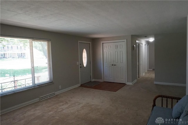 10520 Grand Vista Dr, Dayton, OH 45458 - carpeted entryway with baseboards and a textured ceiling