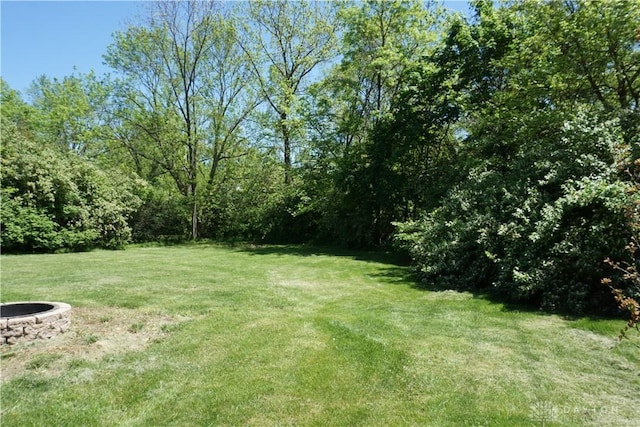 10520 Grand Vista Dr, Dayton, OH 45458 - view of green lawn with a fire pit