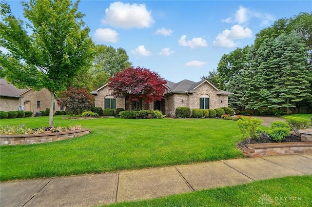 220 Fivepines Ct, Englewood, OH 45315 - view of property hidden behind natural elements with a front yard and brick siding