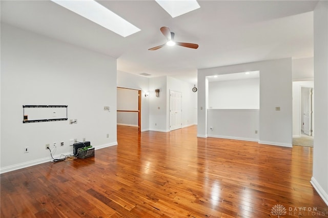 220 Fivepines Ct, Englewood, OH 45315 - unfurnished living room with a skylight, wood-type flooring, a ceiling fan, and baseboards