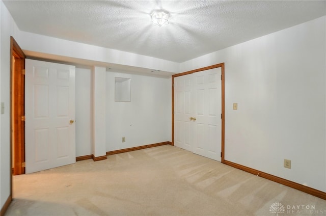 220 Fivepines Ct, Englewood, OH 45315 - unfurnished bedroom with light carpet, baseboards, a closet, and a textured ceiling