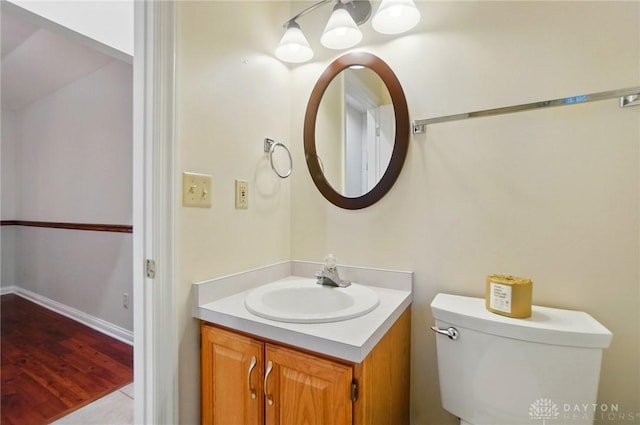 220 Fivepines Ct, Englewood, OH 45315 - half bathroom featuring vanity, toilet, wood finished floors, a chandelier, and baseboards