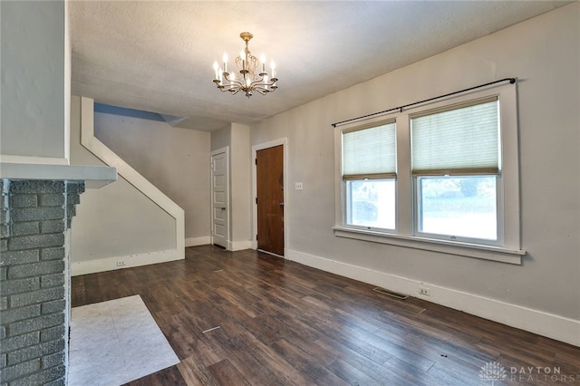 27 S Quentin Ave, Dayton, OH 45403 - unfurnished living room with a chandelier and dark wood-style flooring