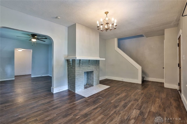 27 S Quentin Ave, Dayton, OH 45403 - unfurnished living room featuring ceiling fan, a chandelier, wood finished floors, a brick fireplace, and a textured ceiling