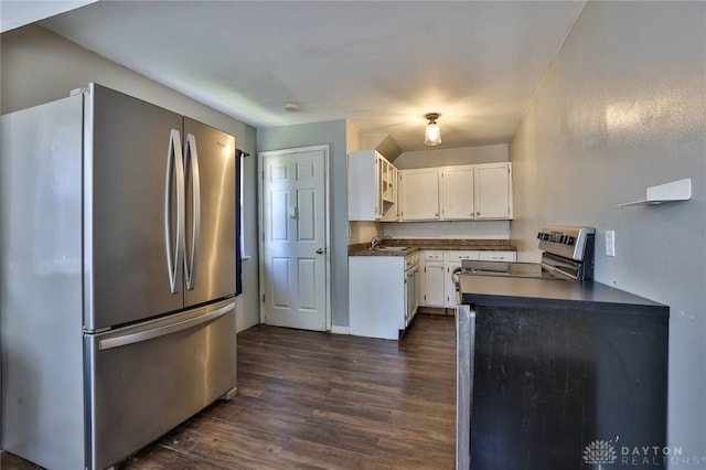 27 S Quentin Ave, Dayton, OH 45403 - kitchen with appliances with stainless steel finishes, dark countertops, dark wood-style floors, and white cabinetry