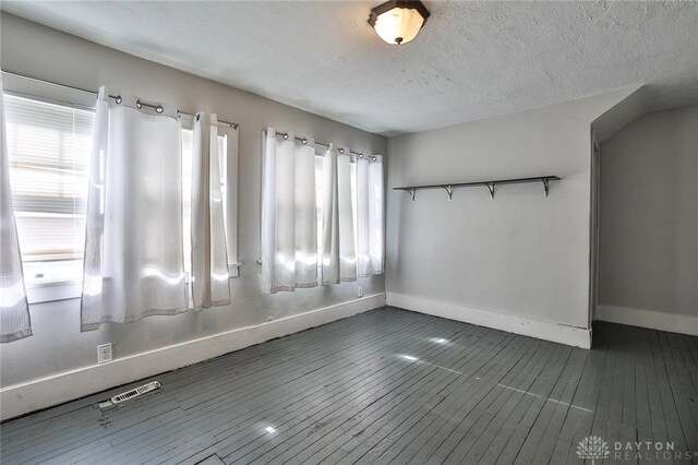 27 S Quentin Ave, Dayton, OH 45403 - unfurnished room with healthy amount of natural light, a textured ceiling, and wood finished floors