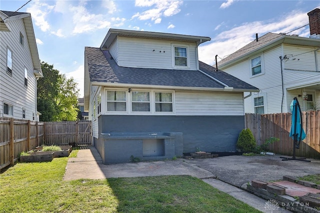 27 S Quentin Ave, Dayton, OH 45403 - back of house with a shingled roof, a vegetable garden, a fenced backyard, and a patio