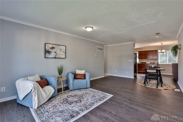 5695 E Coach Dr Unit E, Kettering, OH 45440 - sitting room featuring a chandelier, dark wood-style floors, baseboards, a textured ceiling, and crown molding