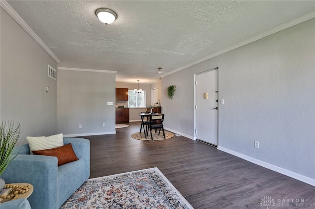 5695 E Coach Dr Unit E, Kettering, OH 45440 - living room featuring dark wood-type flooring, a textured ceiling, a chandelier, baseboards, and crown molding