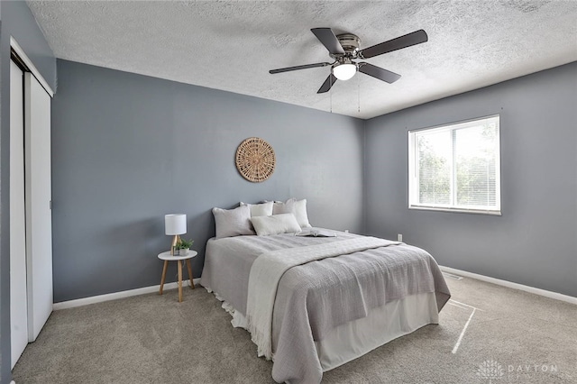 5695 E Coach Dr Unit E, Kettering, OH 45440 - bedroom featuring carpet flooring, baseboards, a textured ceiling, ceiling fan, and a closet