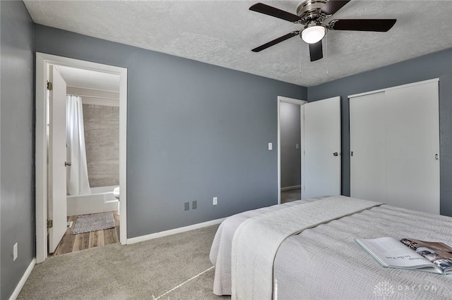 5695 E Coach Dr Unit E, Kettering, OH 45440 - bedroom featuring carpet flooring, baseboards, ensuite bathroom, a textured ceiling, and a closet
