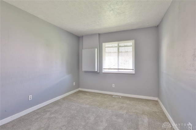 5695 E Coach Dr Unit E, Kettering, OH 45440 - unfurnished room featuring carpet floors, a textured ceiling, and baseboards