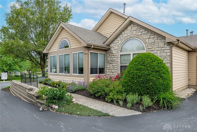 91 Villa Pointe Dr, Springboro, OH 45066 - view of side of property with stone siding and roof with shingles