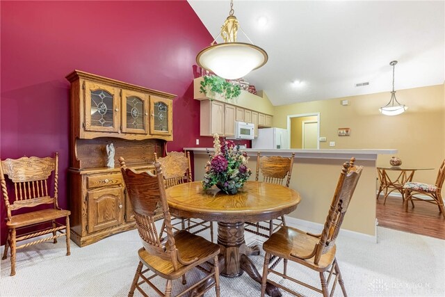 91 Villa Pointe Dr, Springboro, OH 45066 - dining room featuring vaulted ceiling, light carpet, and baseboards