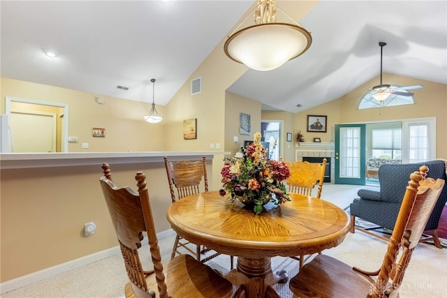 91 Villa Pointe Dr, Springboro, OH 45066 - dining area with vaulted ceiling, ceiling fan, carpet floors, a tile fireplace, and baseboards