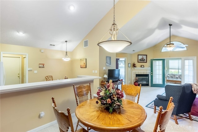 91 Villa Pointe Dr, Springboro, OH 45066 - dining area with lofted ceiling, carpet flooring, a fireplace, ceiling fan, and baseboards