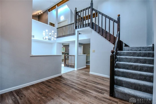 222 Walnut Grove Dr, Centerville, OH 45458 - stairs featuring wood finished floors, baseboards, a chandelier, and a towering ceiling