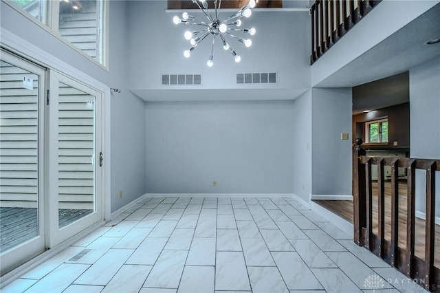222 Walnut Grove Dr, Centerville, OH 45458 - spare room with a towering ceiling, a chandelier, and baseboards