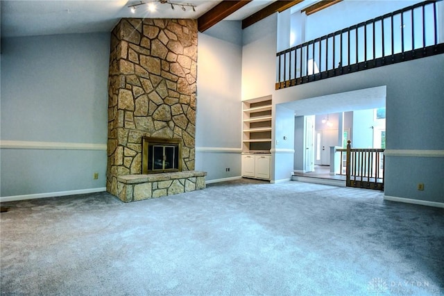 222 Walnut Grove Dr, Centerville, OH 45458 - unfurnished living room with baseboards, a fireplace, beamed ceiling, carpet floors, and high vaulted ceiling