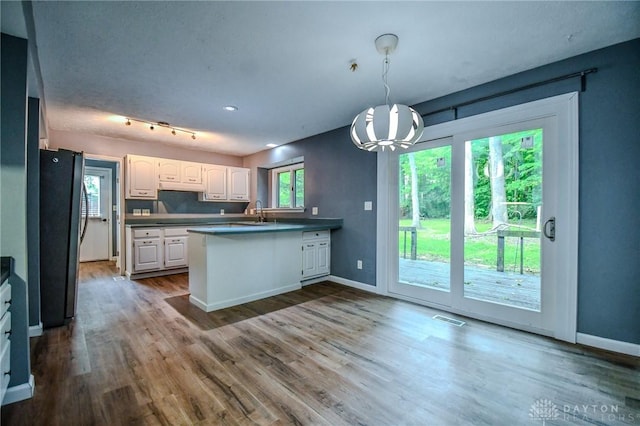 222 Walnut Grove Dr, Centerville, OH 45458 - kitchen with freestanding refrigerator, a peninsula, white cabinets, and baseboards