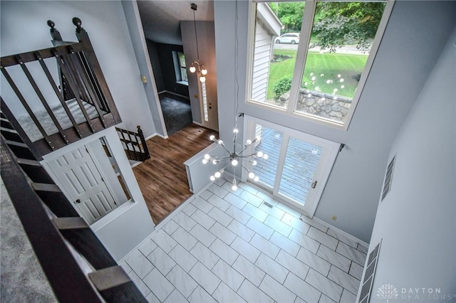 222 Walnut Grove Dr, Centerville, OH 45458 - entrance foyer featuring healthy amount of natural light, wood finished floors, baseboards, and a chandelier