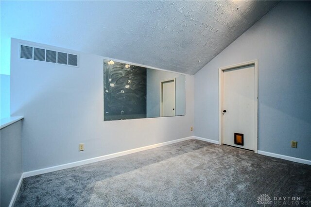 222 Walnut Grove Dr, Centerville, OH 45458 - spare room featuring carpet, baseboards, a textured ceiling, and vaulted ceiling