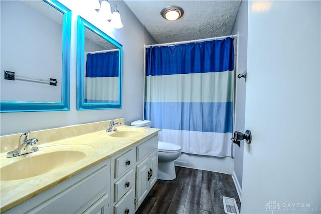 222 Walnut Grove Dr, Centerville, OH 45458 - bathroom with toilet, double vanity, wood finished floors, a textured ceiling, and shower / bath combination with curtain