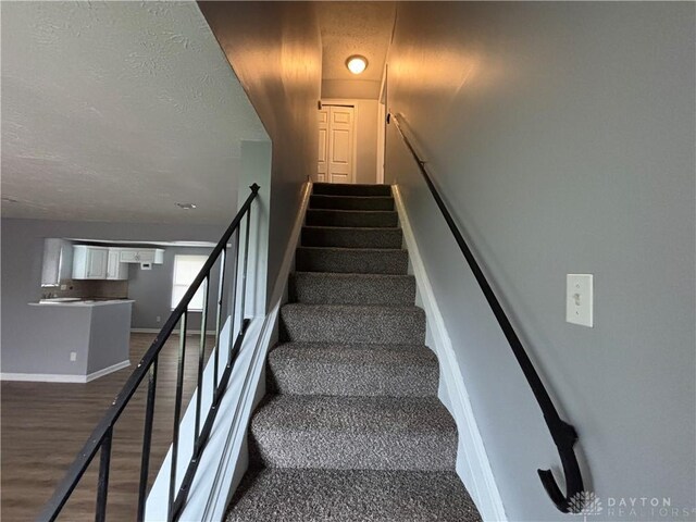 5901 Timbergate Trl, Dayton, OH 45424 - stairs with baseboards, wood finished floors, and a textured ceiling