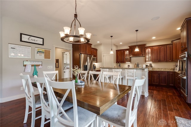 10067 Yearling Run, Dayton, OH 45458 - dining space featuring a chandelier, dark wood-style floors, recessed lighting, and baseboards