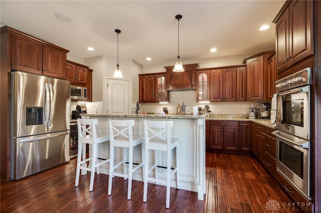 10067 Yearling Run, Dayton, OH 45458 - kitchen with appliances with stainless steel finishes, glass insert cabinets, a breakfast bar, a kitchen island, and dark wood-style floors