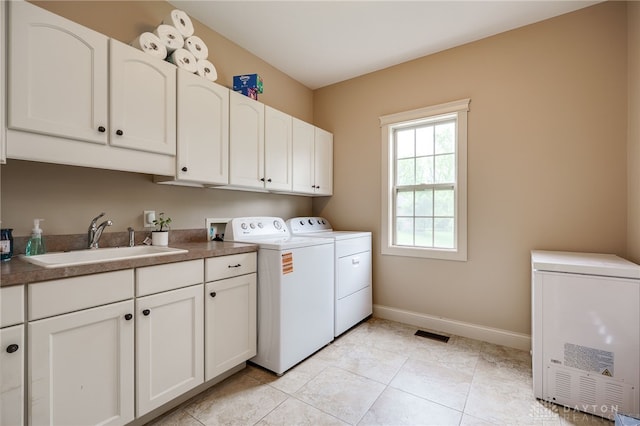 10067 Yearling Run, Dayton, OH 45458 - laundry room with separate washer and dryer, cabinet space, baseboards, and light tile patterned floors