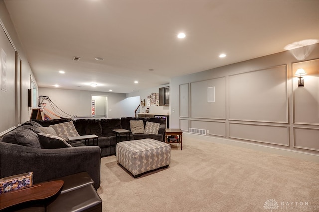 10067 Yearling Run, Dayton, OH 45458 - living room featuring light carpet, a decorative wall, recessed lighting, and stairs