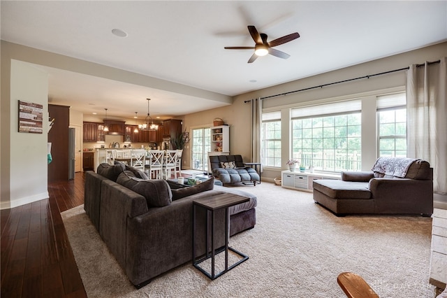 10067 Yearling Run, Dayton, OH 45458 - living room with ceiling fan, a chandelier, baseboards, and hardwood / wood-style floors
