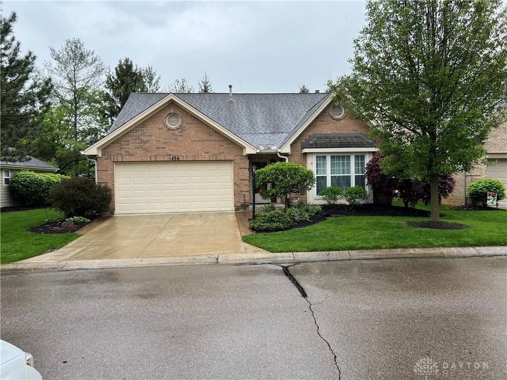 1436 Muirfield Ct, Dayton, OH 45459 - view of front facade featuring driveway, brick siding, a garage, a front yard, and roof with shingles