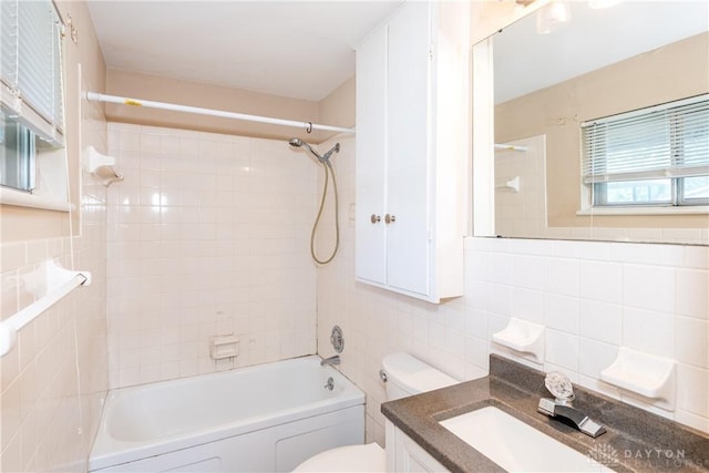 5501 Harshmanville Rd, Dayton, OH 45424 - full bath with tile walls, toilet, washtub / shower combination, and vanity