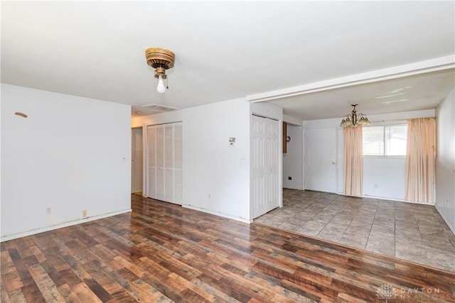 5501 Harshmanville Rd, Dayton, OH 45424 - unfurnished room with wood finished floors, a chandelier, and baseboards