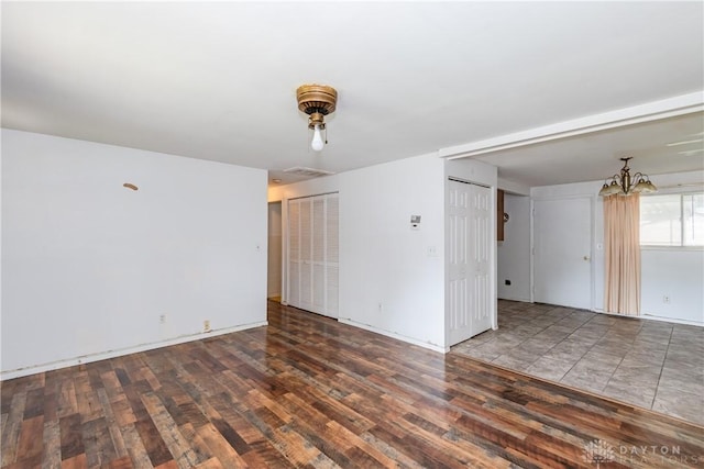 5501 Harshmanville Rd, Dayton, OH 45424 - unfurnished room with wood finished floors, a chandelier, and baseboards